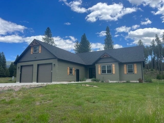 view of front of property with a front yard and a garage