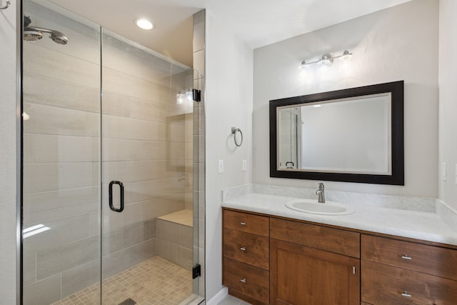 bathroom featuring an enclosed shower and vanity