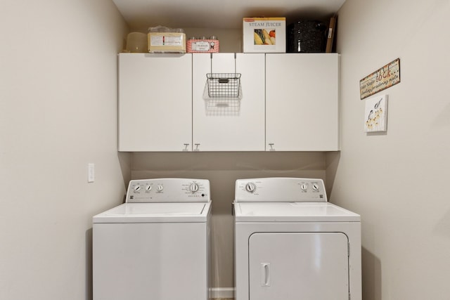 washroom with cabinets and separate washer and dryer