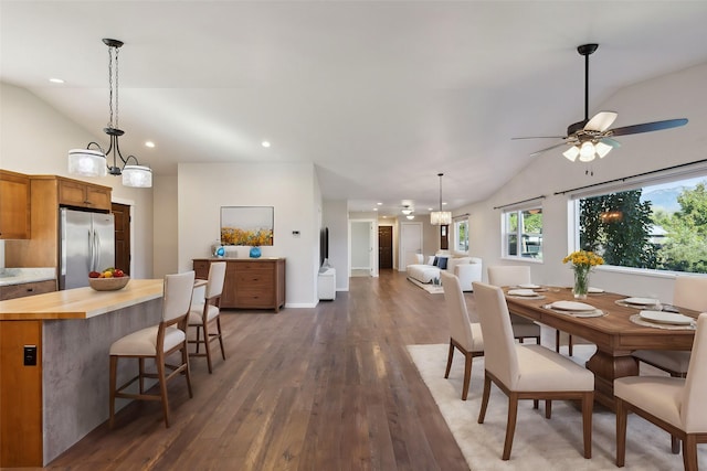 dining space with lofted ceiling, ceiling fan, and dark wood-type flooring