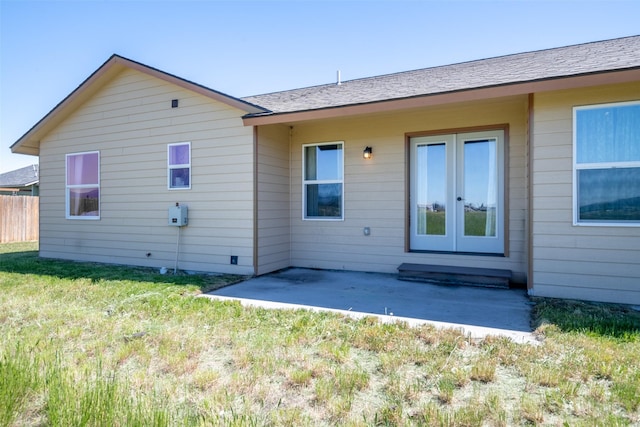 rear view of property with french doors, fence, a yard, and a patio area