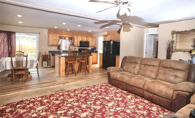 bedroom featuring ceiling fan and carpet