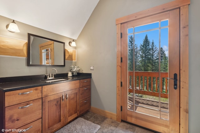 bathroom featuring vanity and vaulted ceiling