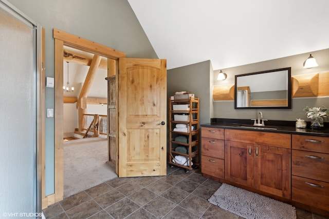 bathroom featuring tile patterned floors, vanity, and lofted ceiling with beams