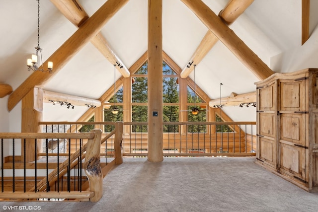 unfurnished living room featuring carpet floors, beamed ceiling, and high vaulted ceiling