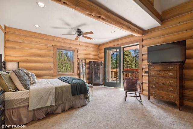 carpeted bedroom with access to exterior, beam ceiling, rustic walls, and multiple windows