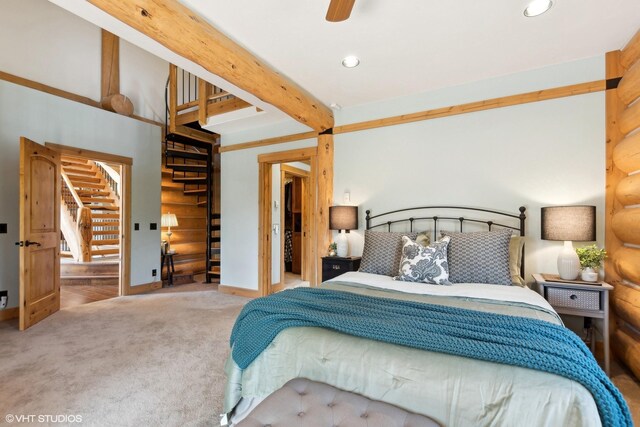 carpeted bedroom featuring beam ceiling and ceiling fan