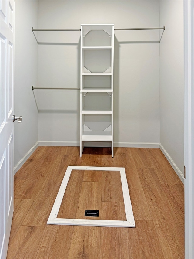 spacious closet featuring hardwood / wood-style floors