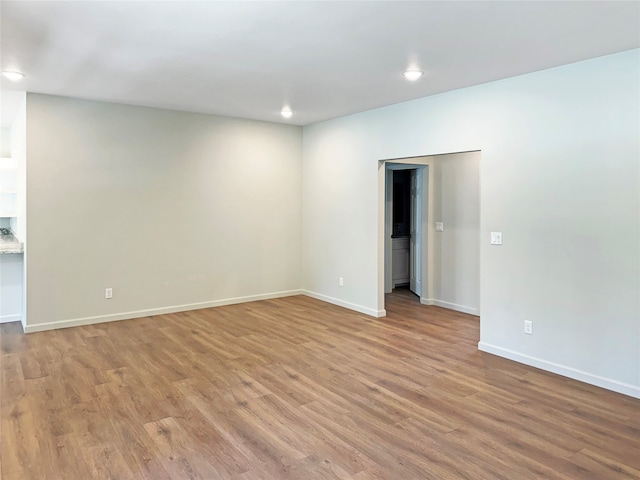 empty room with hardwood / wood-style floors