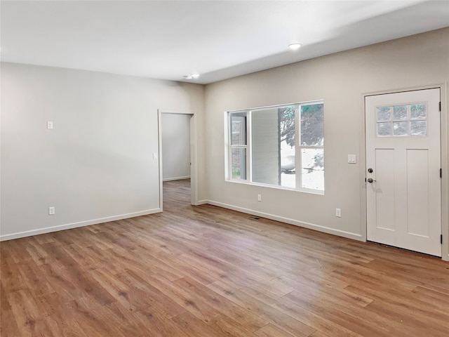 foyer entrance with light hardwood / wood-style floors