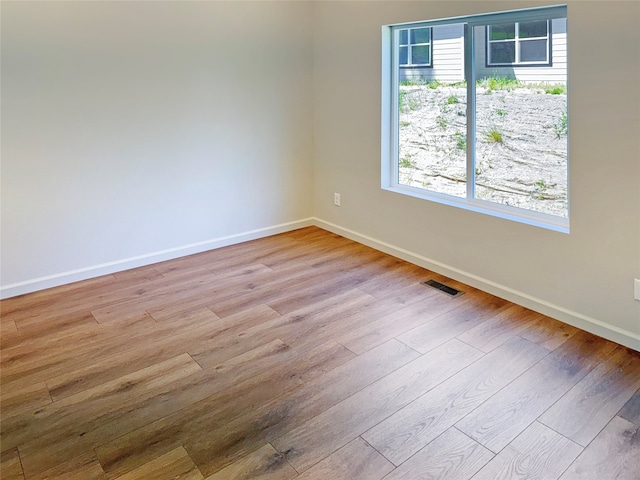 spare room featuring light hardwood / wood-style flooring