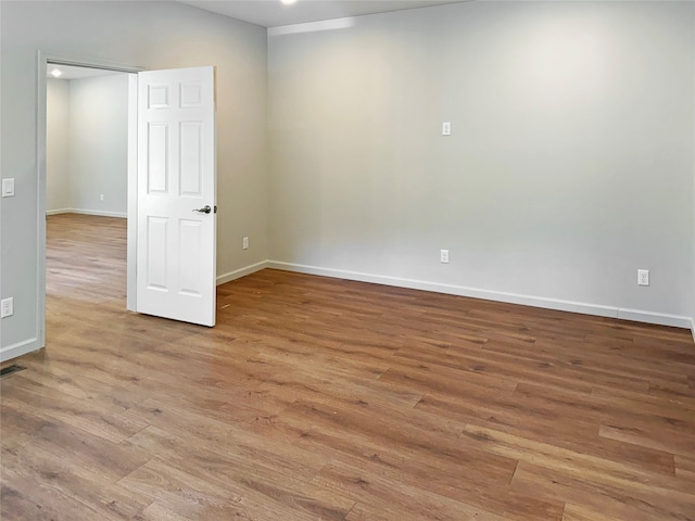 unfurnished room featuring hardwood / wood-style flooring