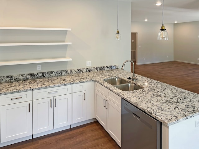 kitchen featuring kitchen peninsula, stainless steel dishwasher, dark hardwood / wood-style flooring, hanging light fixtures, and sink