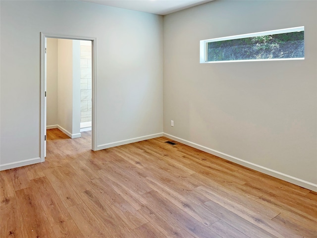 spare room featuring light hardwood / wood-style flooring