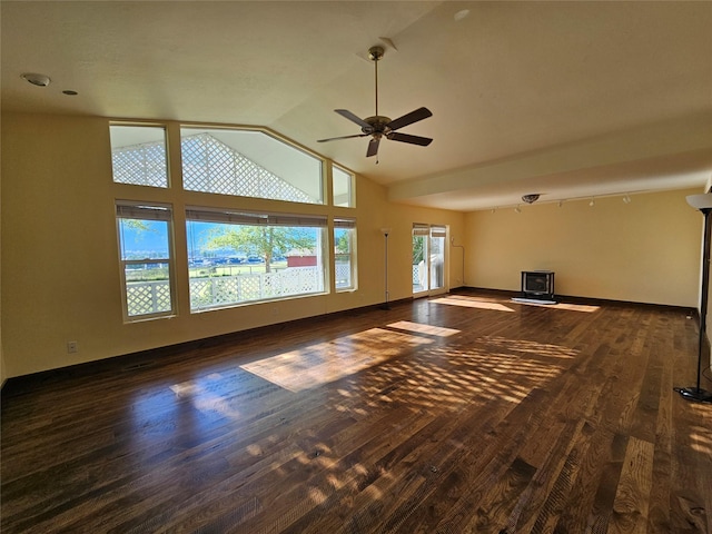 unfurnished living room featuring lofted ceiling, dark hardwood / wood-style floors, and ceiling fan