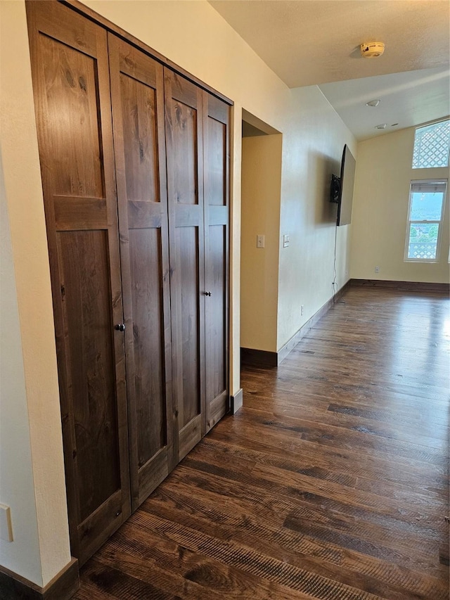 hall with dark wood-type flooring