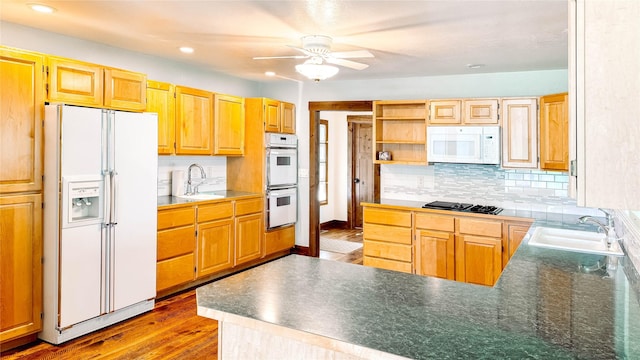 kitchen with white appliances, wood-type flooring, sink, and decorative backsplash