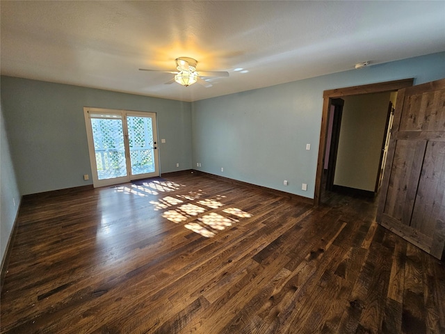 empty room with dark wood-type flooring and ceiling fan