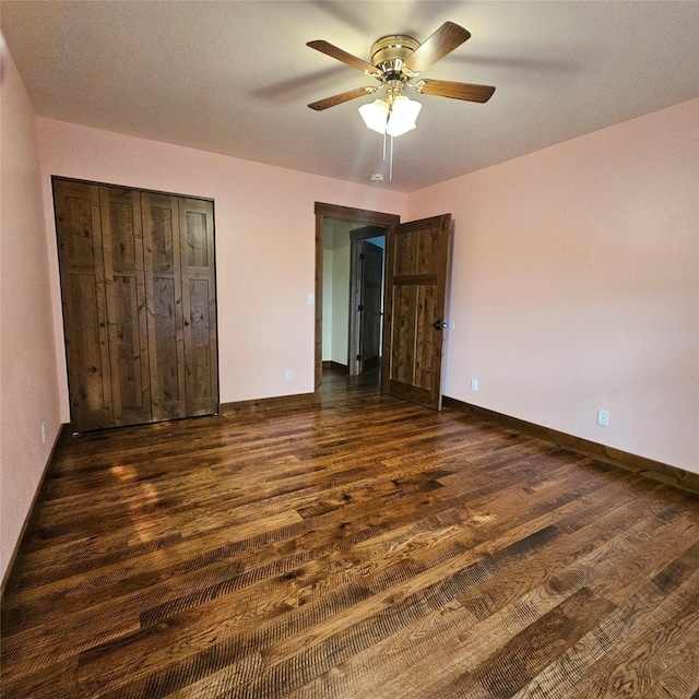 unfurnished bedroom featuring ceiling fan, dark hardwood / wood-style flooring, and a closet