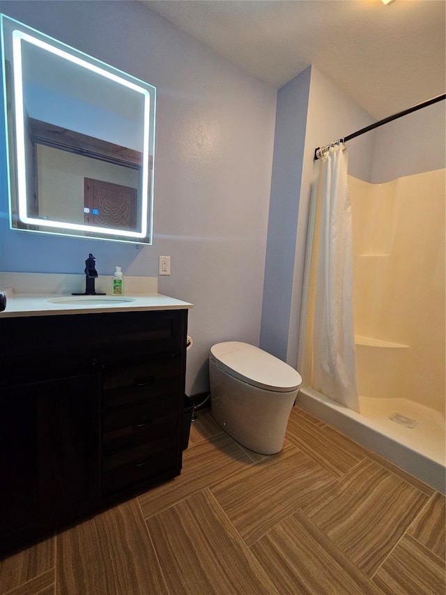 bathroom with vanity, a shower with curtain, and toilet