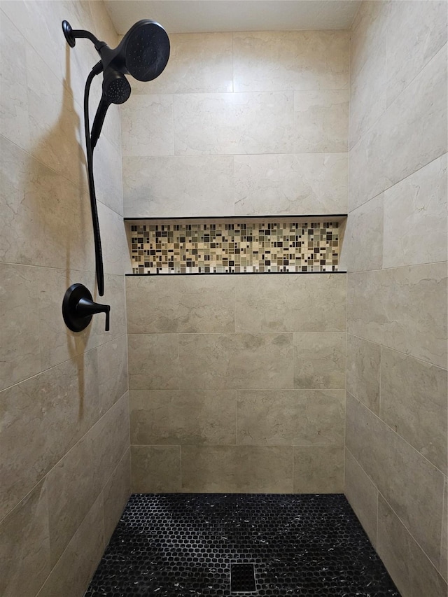 bathroom with a tile shower