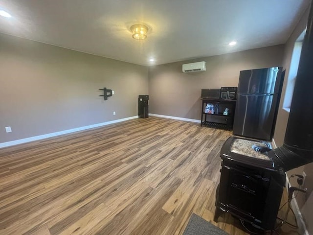 interior space with a wall unit AC and light wood-type flooring