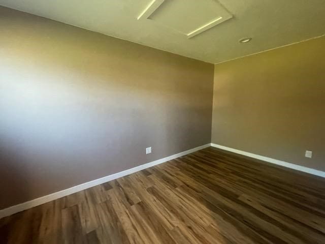 empty room with dark hardwood / wood-style floors