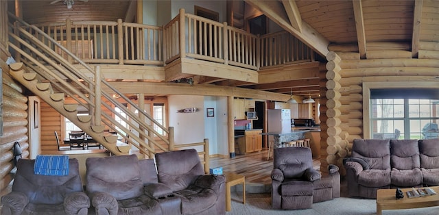 living room featuring rustic walls, plenty of natural light, and light hardwood / wood-style floors