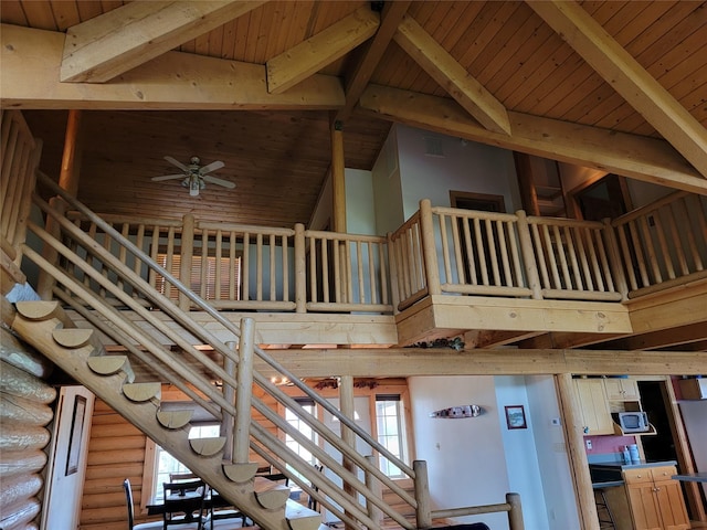 staircase with ceiling fan, high vaulted ceiling, and wood ceiling