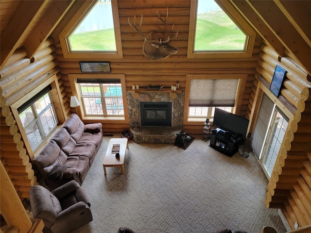 living room with log walls, high vaulted ceiling, and plenty of natural light