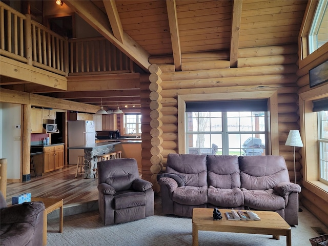 living room with beamed ceiling, wood ceiling, and log walls