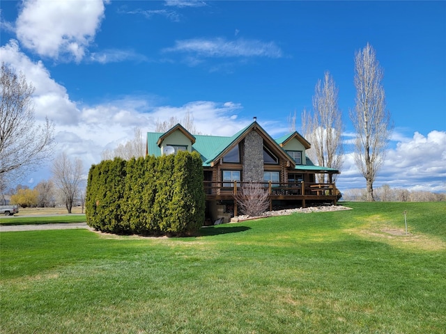 view of front facade with a front yard and a wooden deck