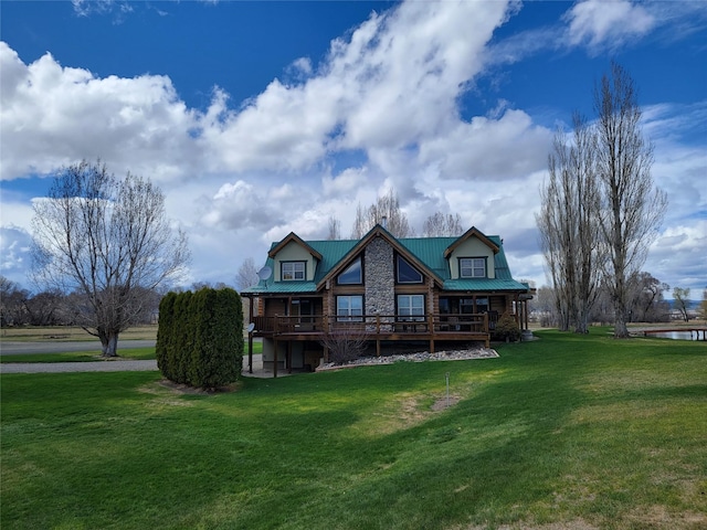 back of property with a water view and a lawn