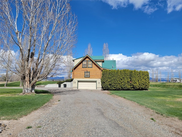 view of front of property with a front yard and a garage