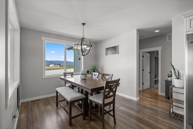 dining space featuring a chandelier, a mountain view, and dark wood-type flooring