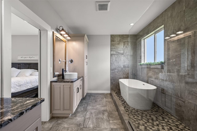 bathroom with vanity and a bath