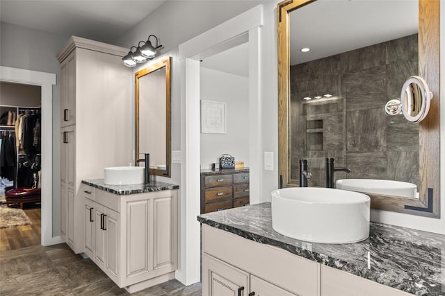 bathroom featuring vanity and tiled shower