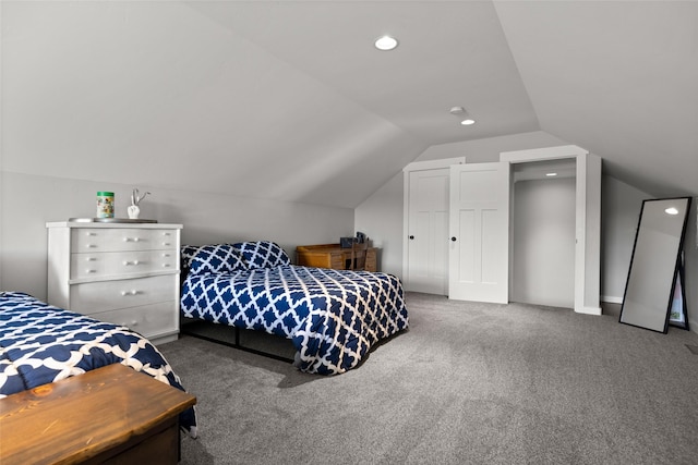 carpeted bedroom with lofted ceiling