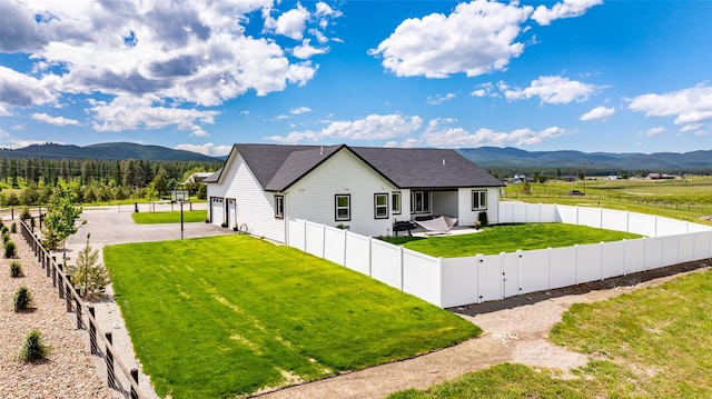 view of front of property with a mountain view and a front lawn