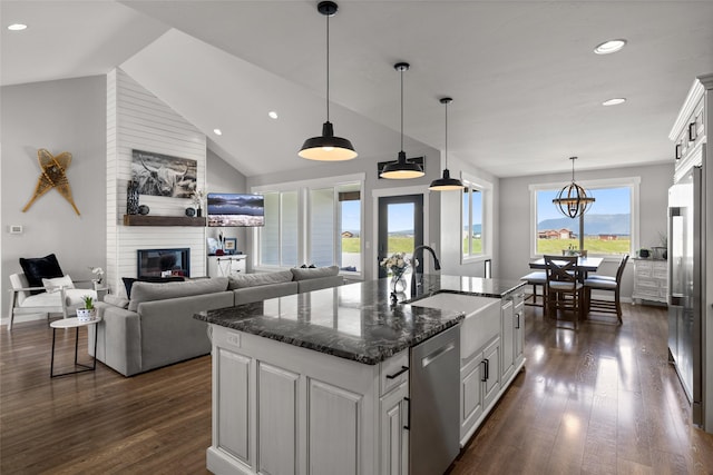 kitchen with sink, appliances with stainless steel finishes, dark hardwood / wood-style floors, a kitchen island with sink, and white cabinets