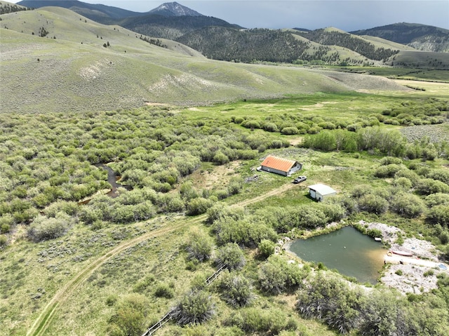 aerial view featuring a rural view and a water and mountain view