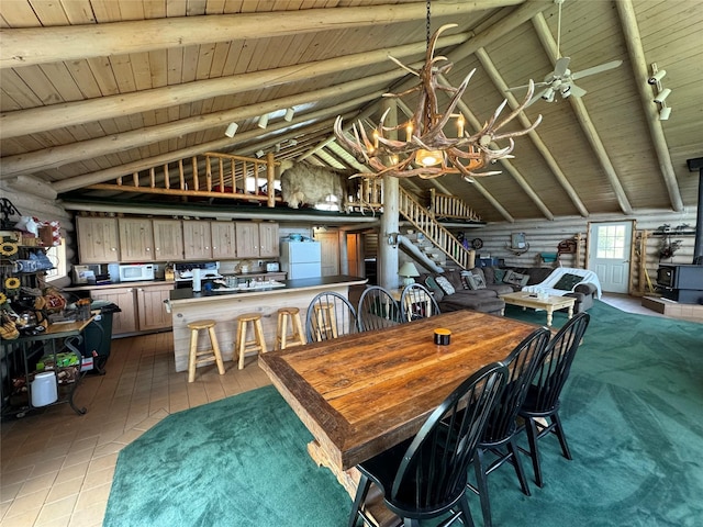 tiled dining space with beam ceiling, wooden ceiling, and rustic walls