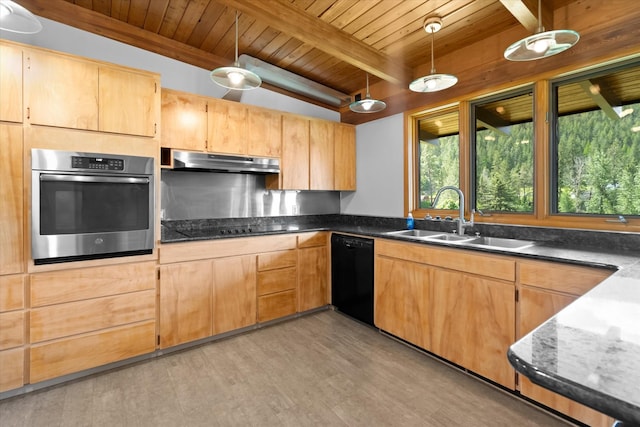 kitchen featuring decorative light fixtures, dark countertops, a sink, under cabinet range hood, and black appliances