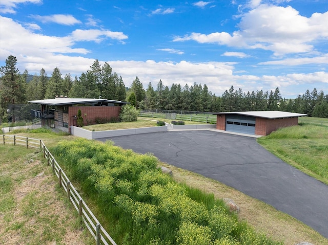 view of street with driveway and a rural view