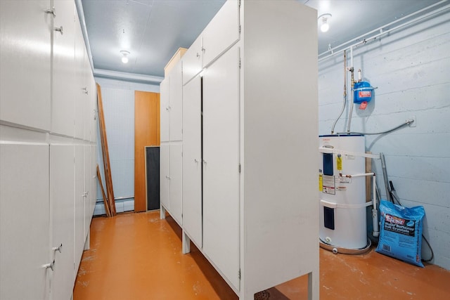 hallway featuring concrete block wall, secured water heater, concrete floors, and a baseboard radiator