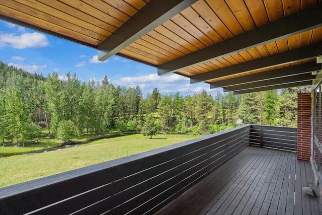 wooden terrace featuring a yard