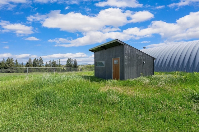 view of outbuilding with an outdoor structure and fence