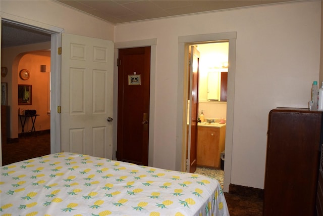 bedroom with ensuite bathroom and sink