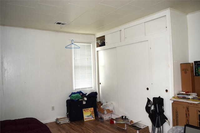 bedroom featuring wood-type flooring and a closet