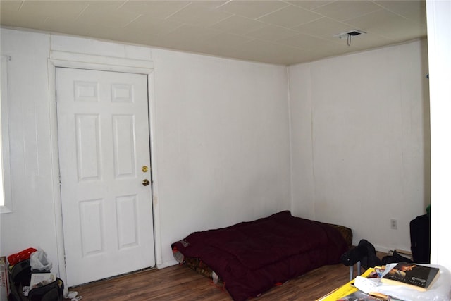 bedroom with dark hardwood / wood-style floors